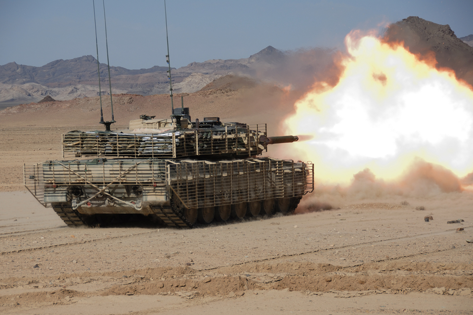 Zarhey, Afghanistan. 18 February 2008 - A Canadian Leopard 2 tank from C Squadron, Lord Strathcona's Horse (LdSH), fires during a firing-range exercise to adjust the 120-mm guns, near an advanced operations base in the Panjwayi district of Afghanistan. (Photo by: Cpl Simon Duchesne, HQ, JTF AFG, ROTO 4)
