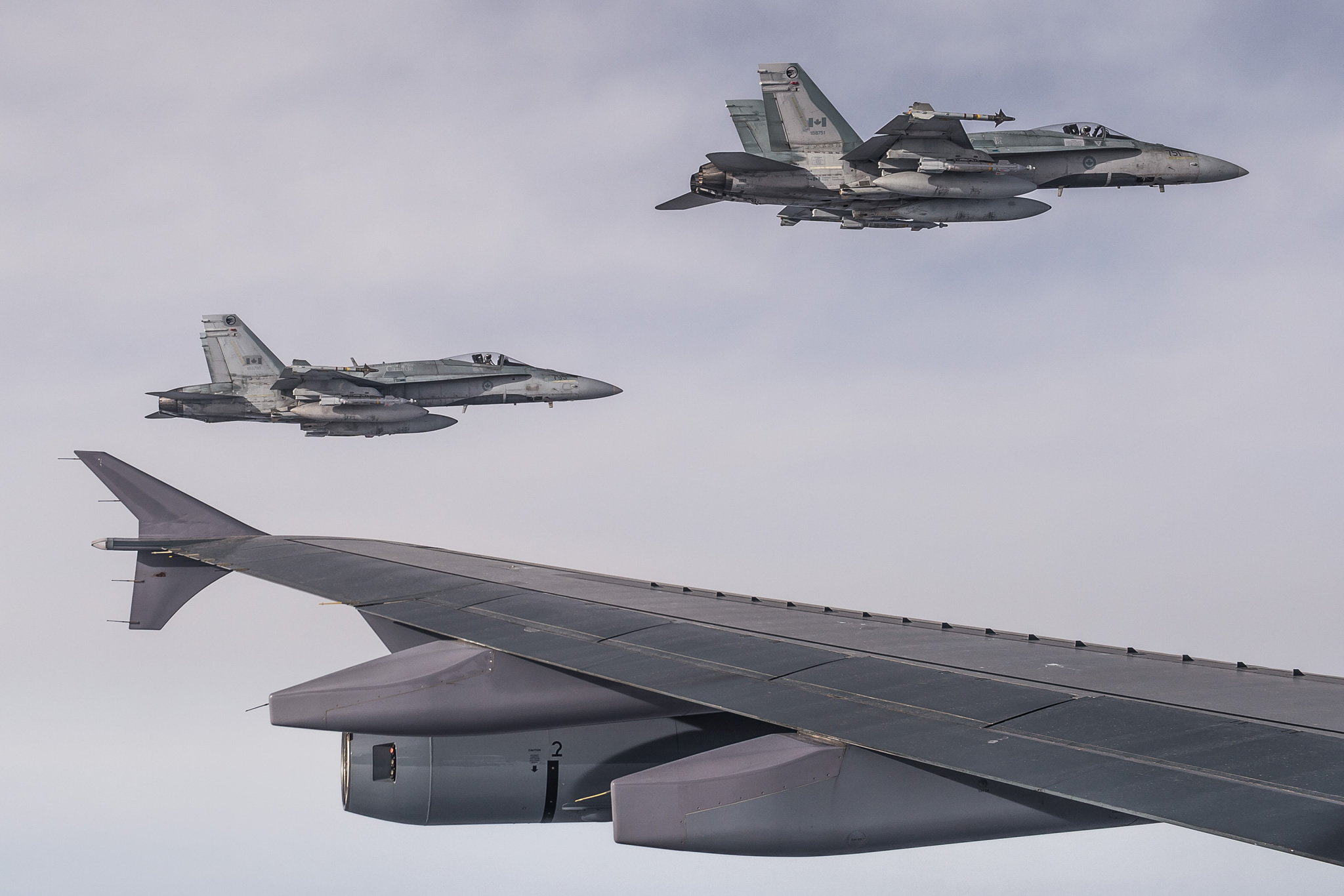 4 February 2015 - Two CF-18 Hornets escort a CC-150 Polaris after being refueled during Operation IMPACT on February 4, 2015. (Photo: Canadian Forces Combat Camera, DND)